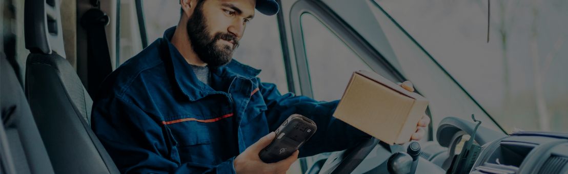 Delivery worker scanning package with handheld computer